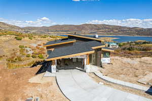Property in mid-construction featuring a mountain view, covered porch, and board and batten siding