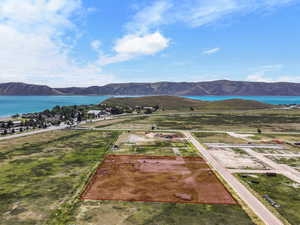 Aerial overview of property's location with a water and mountain view and property boundaries highlighted