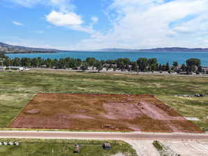 Aerial overview of property's location featuring property boundaries highlighted and a water and mountain view