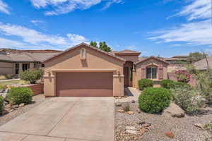 Mediterranean / spanish-style home with stucco siding, an attached garage, concrete driveway, and a tile roof