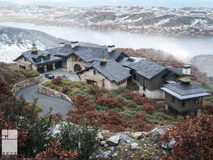 Aerial view of property and surrounding area featuring a mountain backdrop