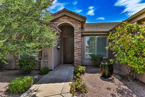 Property entrance with stone and stucco, and a tile roof