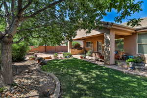 View of yard with an outdoor kitchen and a patio