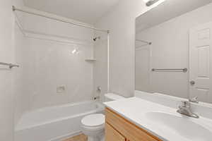 Bathroom featuring vanity, shower / bathtub combination, and tile patterned flooring