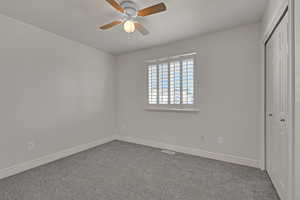 Unfurnished bedroom featuring a closet, carpet, and a ceiling fan