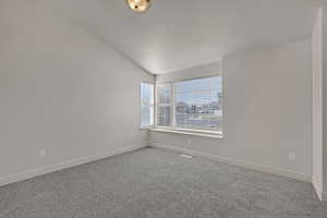 Carpeted spare room with baseboards and a textured ceiling