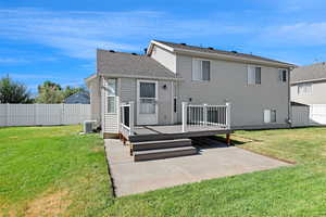Back of house with a patio and a deck