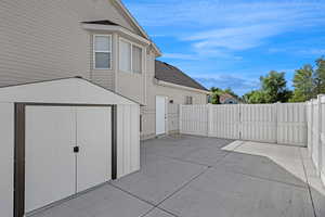 View of patio / terrace with a storage unit and a gate