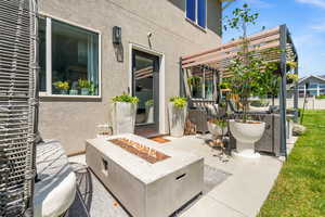 View of patio / terrace featuring a pergola and an outdoor living space with a fire pit