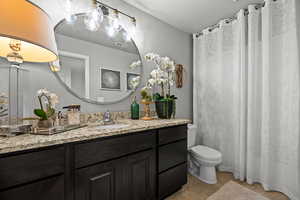 Bathroom featuring vanity, tile patterned floors, and curtained shower