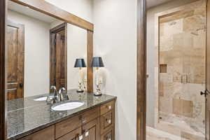 Bathroom featuring a stall shower and vanity