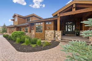 View of front of home featuring stone siding and a porch