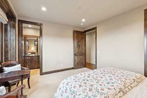 Bedroom with recessed lighting and light colored carpet