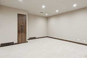 Unfurnished room with carpet floors and recessed lighting