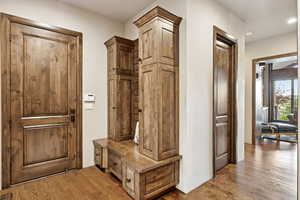 Mudroom featuring dark wood-style floors