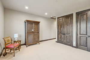 Sitting room featuring light colored carpet and recessed lighting