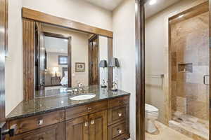 Bathroom featuring vanity, ensuite bath, a shower stall, and recessed lighting