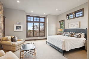 Carpeted bedroom with recessed lighting and baseboards