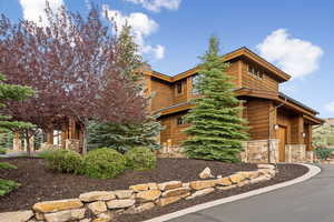 View of side of home featuring stone siding