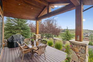 Wooden deck with area for grilling and outdoor dining space