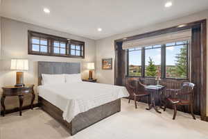 Carpeted bedroom with recessed lighting and baseboards