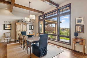 Dining room featuring wood finished floors and beamed ceiling