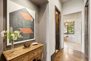 Corridor featuring wood finished floors