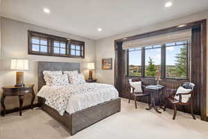 Bedroom featuring light carpet and recessed lighting