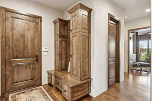 Mudroom featuring dark wood-style floors