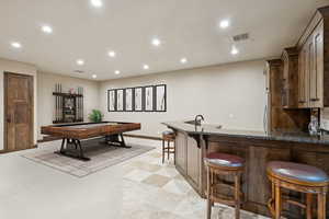 Game room featuring recessed lighting and bar with sink