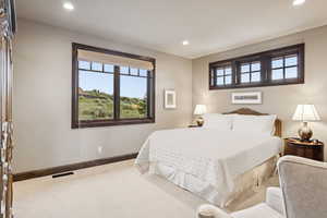 Carpeted bedroom featuring recessed lighting and baseboards