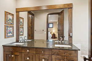 Full bath with double vanity and connected bathroom