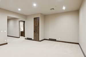 Unfurnished room featuring recessed lighting and carpet floors