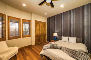 Bedroom with wood finished floors, recessed lighting, and a ceiling fan