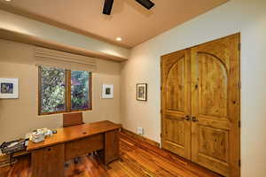 Office with hardwood / wood-style floors, a ceiling fan, and recessed lighting