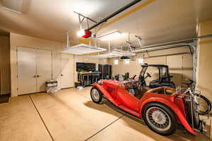 Garage with a garage door opener and refrigerator