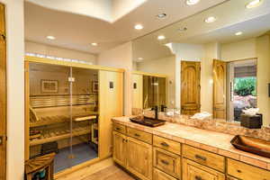 Bathroom with double vanity, recessed lighting, and tile patterned flooring