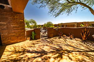 View of patio / terrace with a garage and a gate