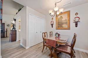 Dining room with a chandelier and light wood-style flooring
