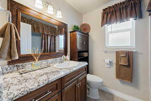 Full bath with vanity and tile patterned flooring