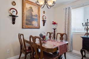 Dining area featuring a chandelier and wood finished floors