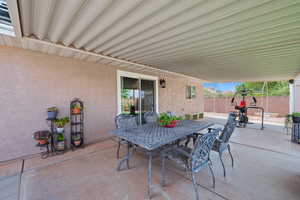 Fenced backyard featuring outdoor dining area and a patio