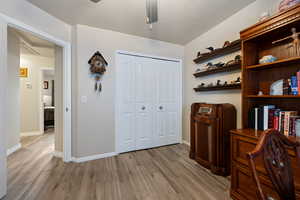 Office with wood finished floors and ceiling fan