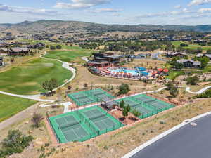 Aerial perspective of suburban area with mountains and a golf club