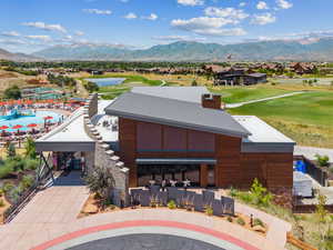 Aerial view of residential area with a local golf course and a water and mountain view