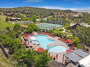 View of pool with a pool with connected hot tub and a residential view