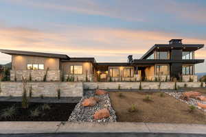 View of front of home featuring stone siding and a porch