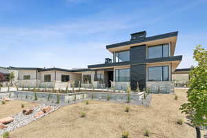 Rear view of house with stone siding