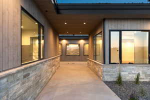 View of exterior entry featuring stone siding