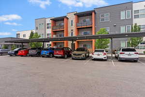 View of property with covered parking